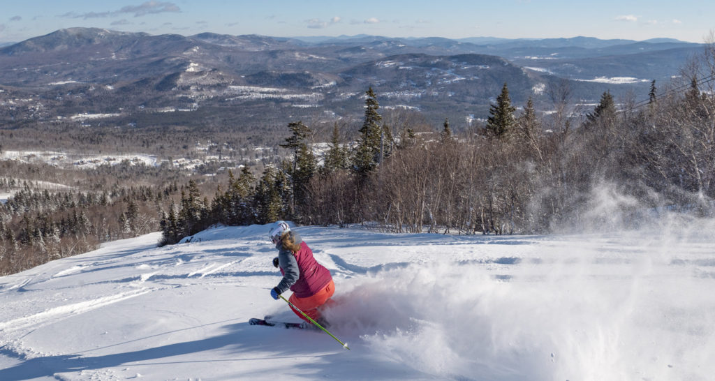 Skiier going down the slopes, Photo Courtesy of Sunday River Skiier going down the slopes, Photo Courtesy of Sunday River
