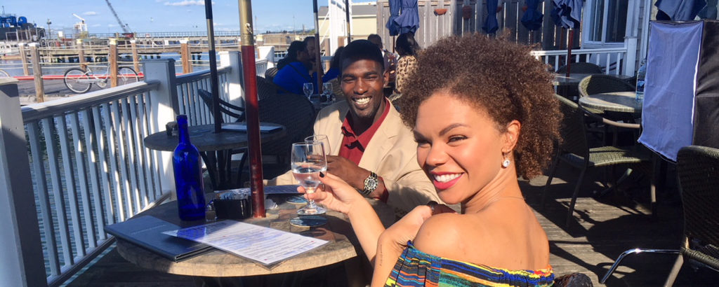 Couple at Waterfront Raising a Glass. Photo Credit: Robert Witkowski Saltwater Patio, Photo Credit: Robert Witkowski