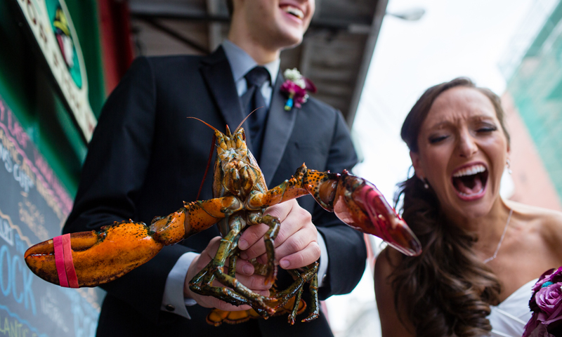 Couple Kissing Holding Lobster, Photo Credit: Emilie Inc. Couple Kissing Holding Lobster, Photo Credit: Emilie Inc.