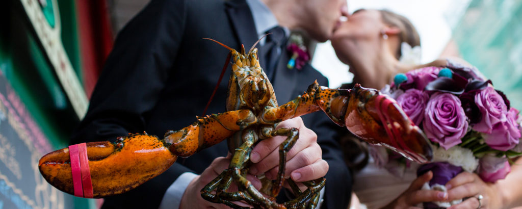 Couple Kissing Holding Lobster, Photo Credit: Emilie Inc. Couple Kissing Holding Lobster, Photo Credit: Emilie Inc.