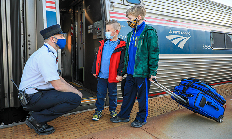 Kids and Conductor Boarding Amtrak Downeaster. Photo Courtesy of NNEPRA Kids and Conductor Boarding Amtrak Downeaster. Photo Courtesy of NNEPRA
